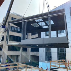 A crane lifting a section of a wind tunnel